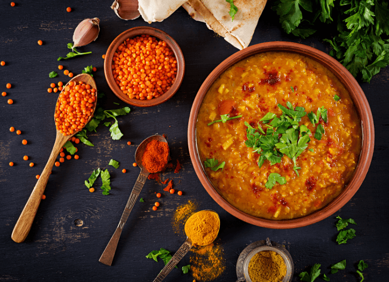 traditional-indian-soup-lentils-indian-dhal-spicy-curry-bowl-spices-herbs-rustic-black-wooden-table